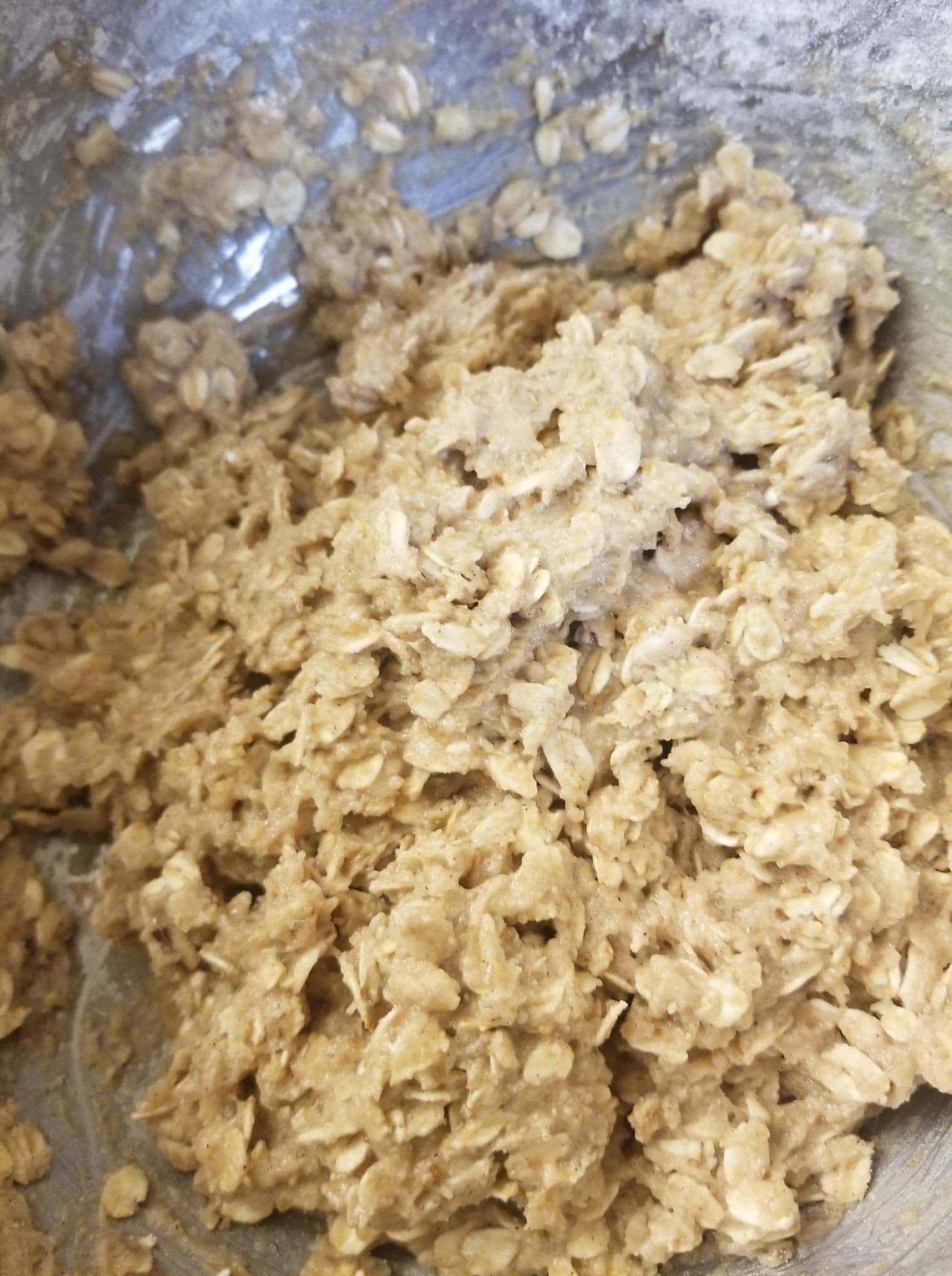 oatmeal cookie batter in a silver bowl
