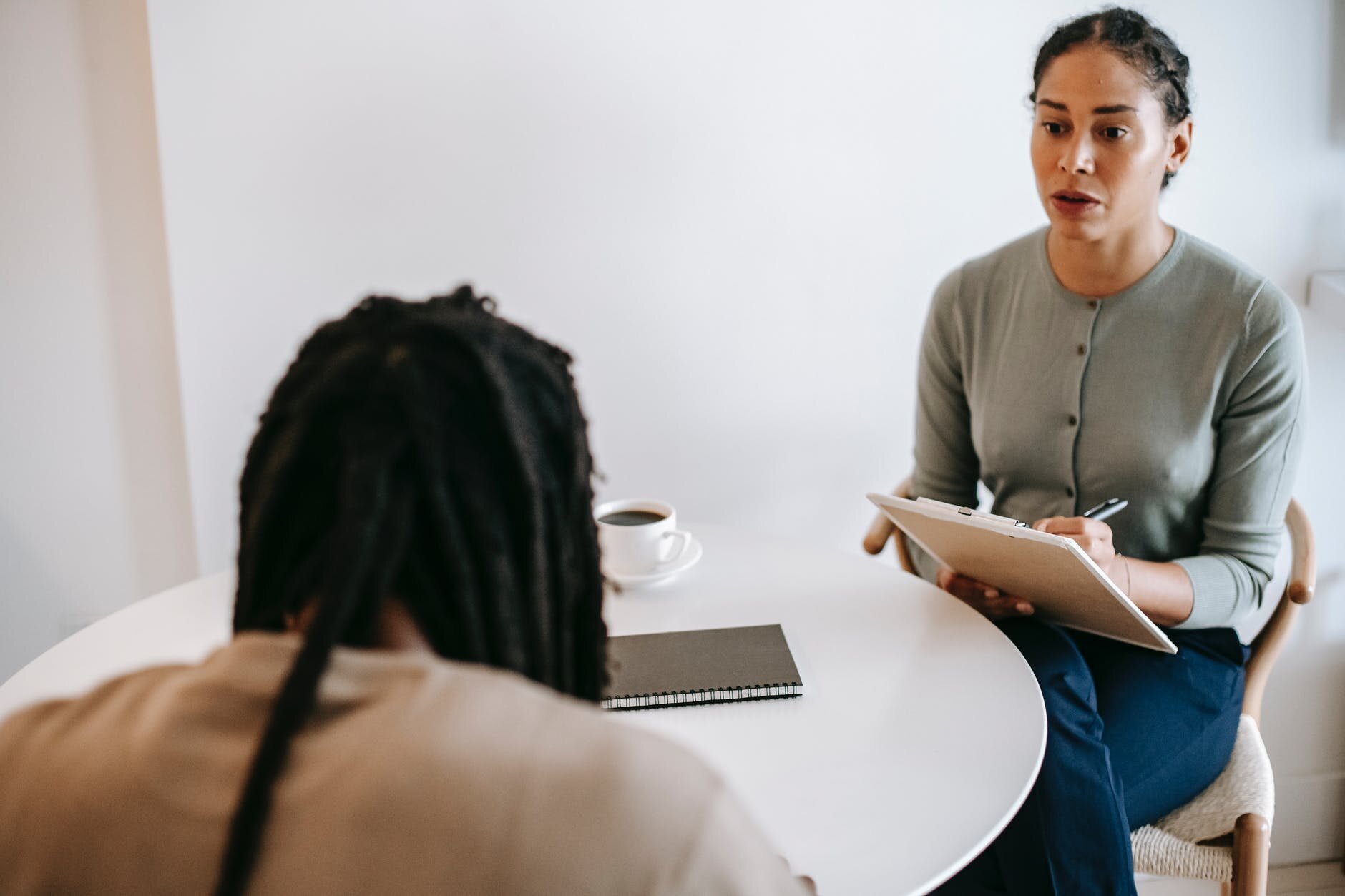 professional female psychotherapist discussing therapy results with male client