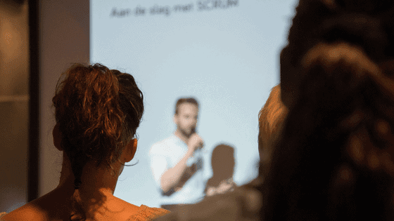 a group of people listening to a speaker How to Hire a Product Manager