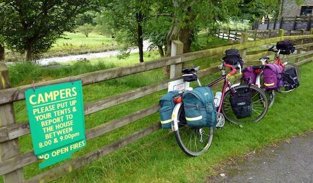 Touring bikes loaded up with gear and parked at a campsite