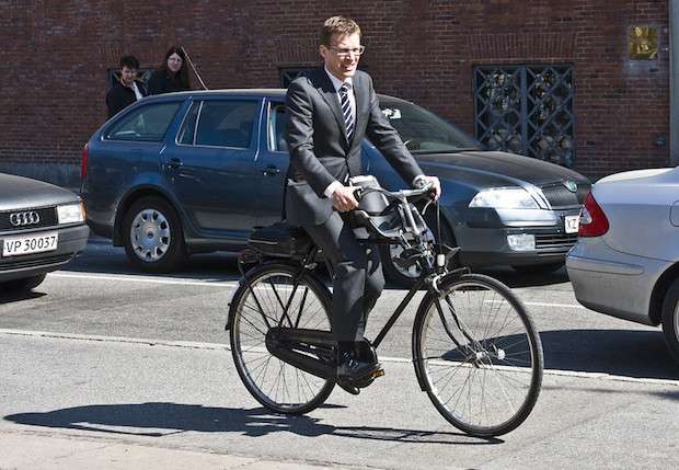 Man cycling while wearing a nice suit