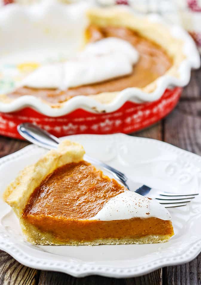 Vegan Sweet Potato Pie with a slice on a white plate with the pie plate in the background