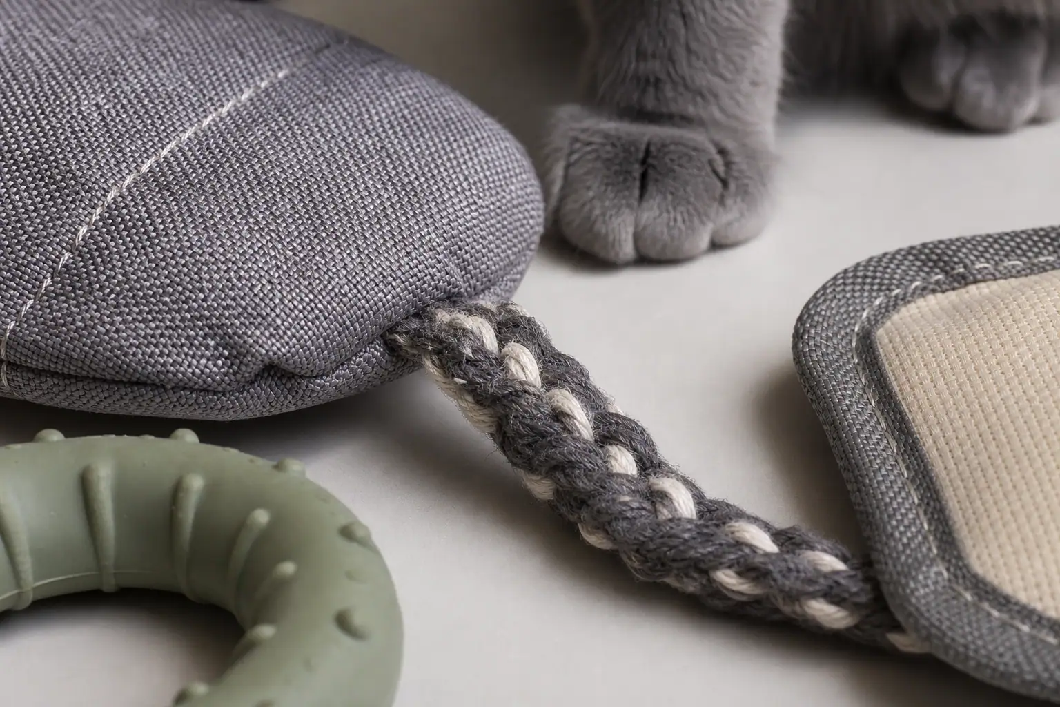 Close view of durable cat toy materials including dense fabric, rubber, and stitched seams