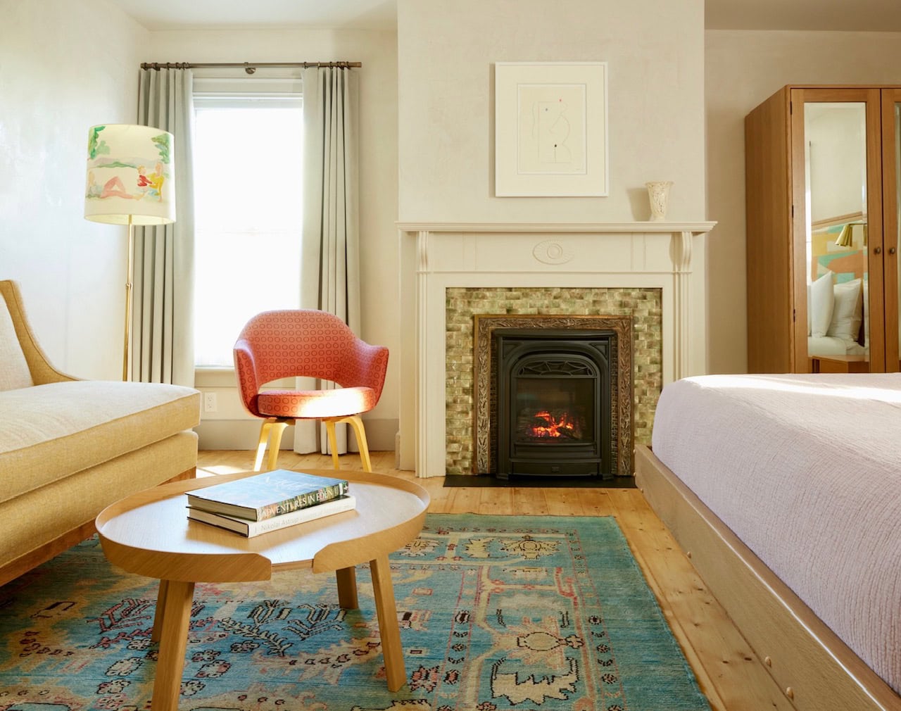 One of Hotel Kinsley's John Street Luxury Queen rooms, with a bright and spring-like feel thanks to lighter wood finishes and mid century modern furnishings accented with a bright Moroccan wool rug.