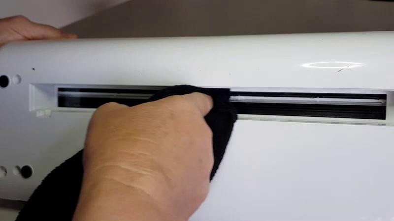 Scan N Cut scanner glass being cleaned with a damp micro fibre cloth