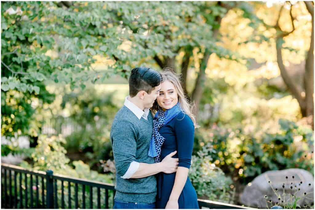 engaged couple hugging, she is looking away and he is looking at her, in Chicago Lincoln Park the best spot for engagement session shoot by bozena voytko