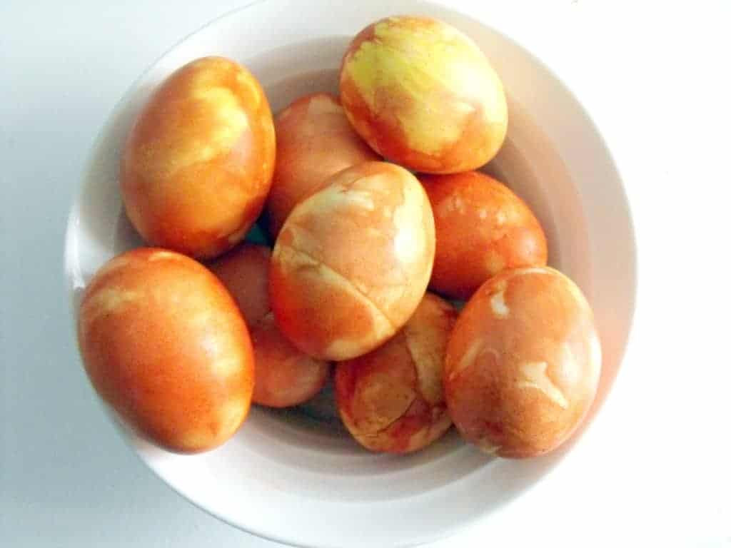 dyed eggs in a white bowl