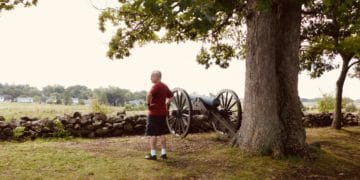A man takes in the gettysburg battlefield from seminary ridge.