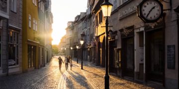 Family walking in a european city pedestrian zone at sunset