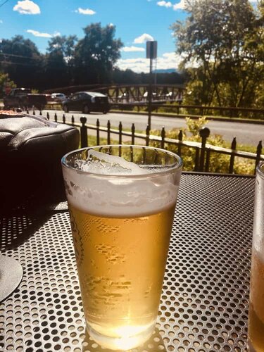 A pint of summer beer with a view of fields and the gunks at clemson brothers brewpub in new paltz, ny