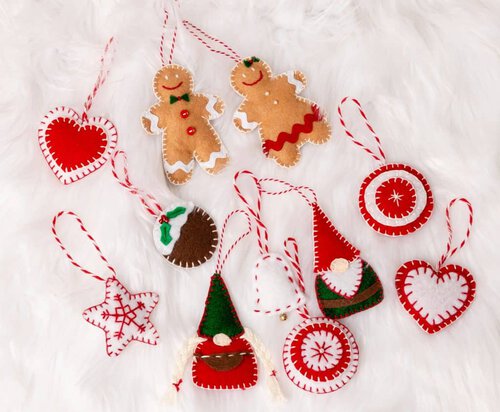 felt ornaments on a white fur background.