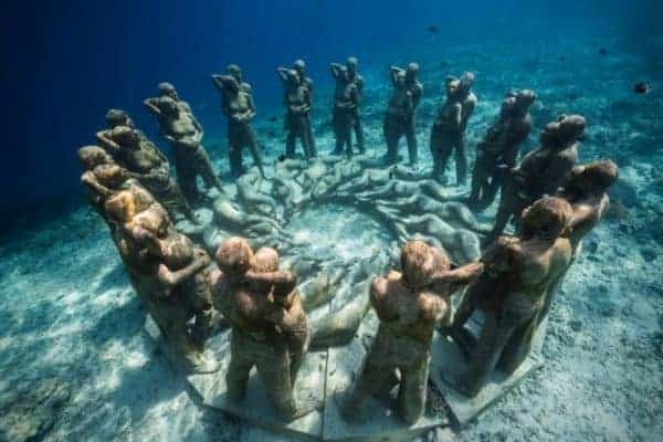 Stone men and women under water off of moliniere point, grenada
