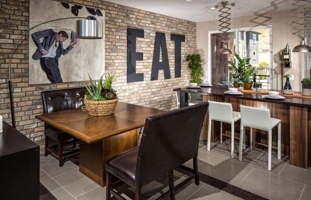 a dining room accent wall made from thin brick tile