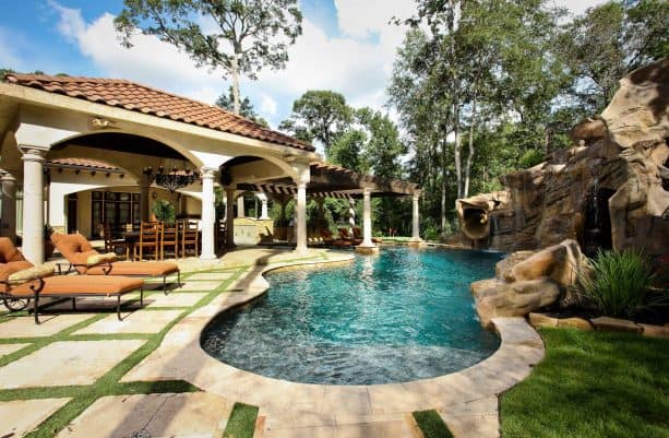 small inground pool with stunning full-size grotto