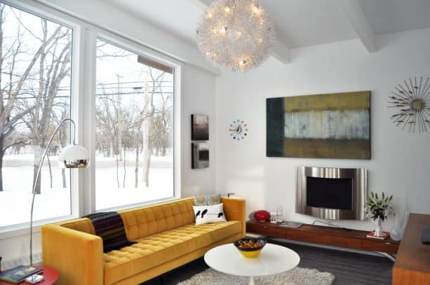 sleek mustard yellow sofa in a light grey living room