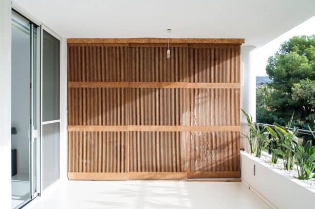 the closed laundry closet doors give a decorative value to the balcony design