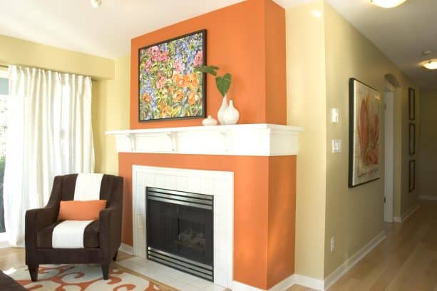 contemporary living room with white interior trim, Benjamin Moore Adams Gold HC-18 wall color and Benjamin Moore Racing Orange 2169-10 fireplace wall color combinations