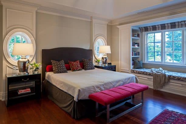 grey bedroom with red bed-end bench