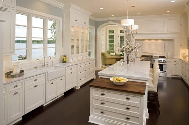 off-white kitchen cabinets featuring a butcher block top for pastry counter