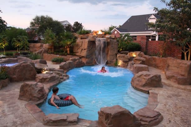 small rustic pool with waterfall feature
