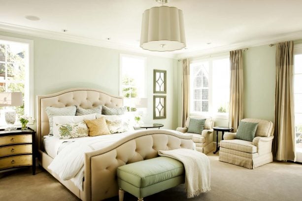 a traditional bedroom with tan and pale green color scheme