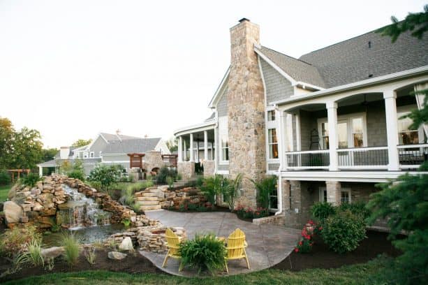 a traditional walkout basement patio with pond