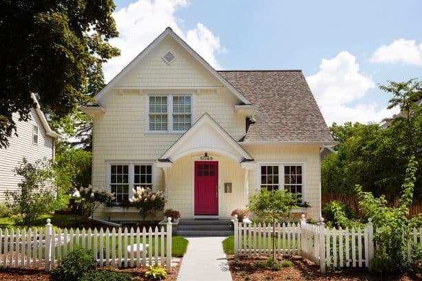 stunning red door in a pale yellow house with white trim design