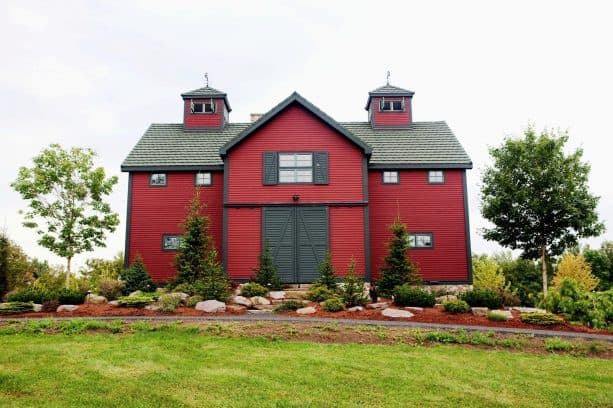 a bold Barn Red farmhouse exterior with black trim and doors
