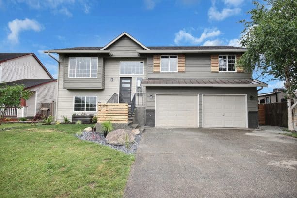 a farmhouse exterior with Amazing Gray SW 7044 and two other greige paint colors