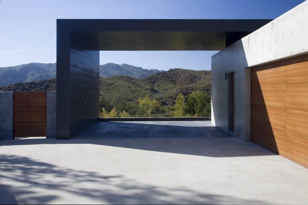 a modern architectural carport with green mountain view at the back