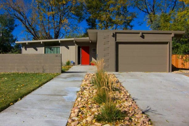 a welcoming exterior with taupe cinder block walls and fence