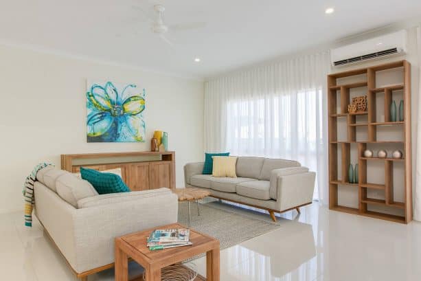 grey and teal living room with unfinished wooden furniture pieces