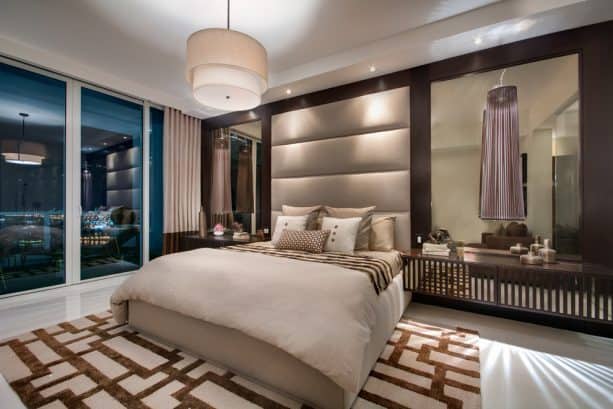 a contemporary bedroom with tan and dark brown color scheme