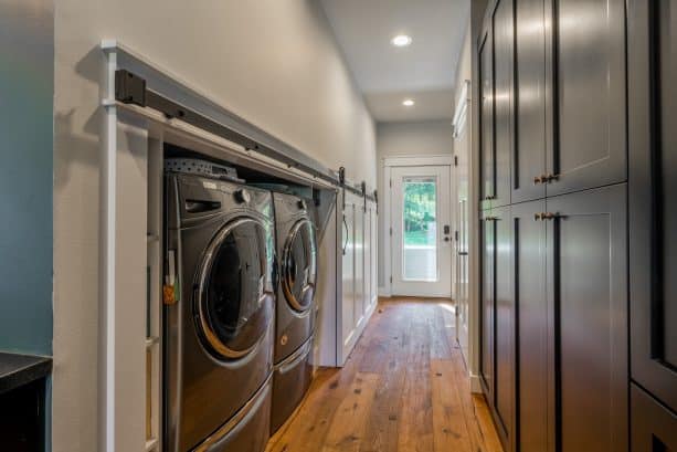 a low laundry closet with special white sliding door
