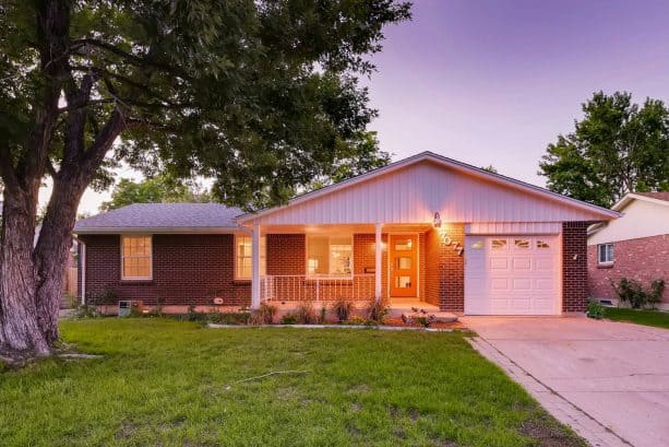 a red brick exterior of a ranch-style house got repainted for a newer look