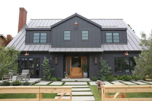 a dark farmhouse exterior with Wrought Iron 2124-10 black paint color from Benjamin Moore