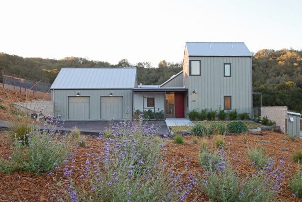 a warm two-tone farmhouse exterior with Sage Mountain 1488 and Winterwood 1486 colors