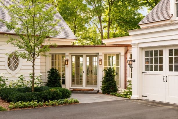 beach-style covered walkway looks stunning with antique white color and French doors