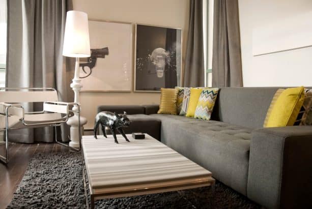 grey sectional couch with mustard cushions