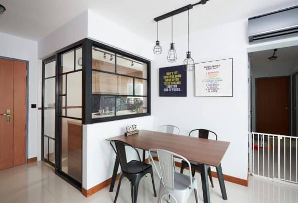 a small kitchen with black-framed door and interior windows