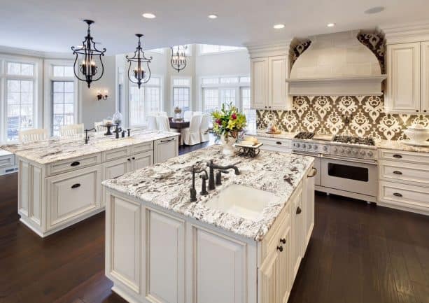 cream kitchen cabinets with white black-veined granite countertops