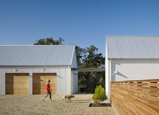the house and the farmhouse garage is connected with a walkway covered with a roof-extension from the main building