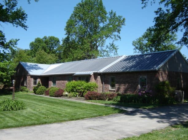 the use of solar metal roof in a modern brick house