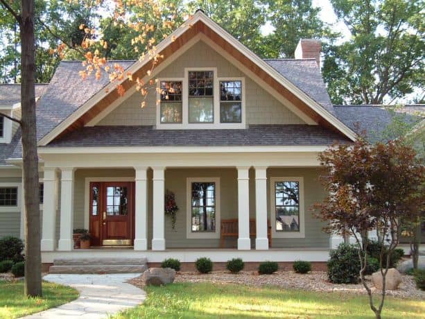 a greige craftsman house with brown roof shingles