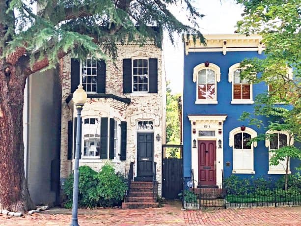 an elegant cobalt blue house with burgundy red front door