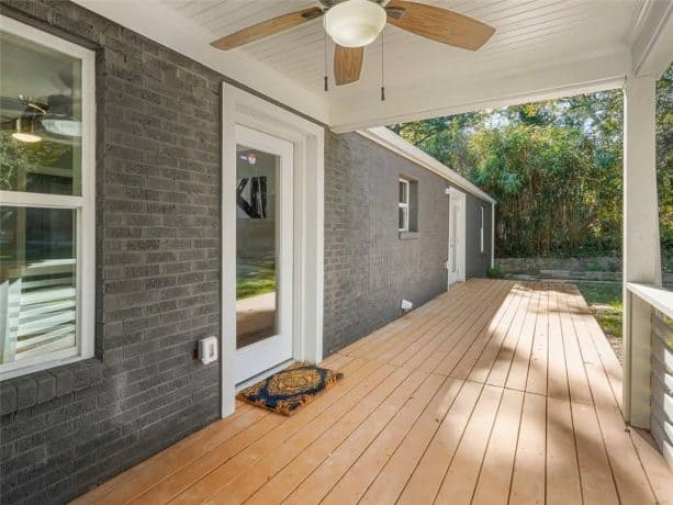 grey painted ranch house exterior with white windows and doors