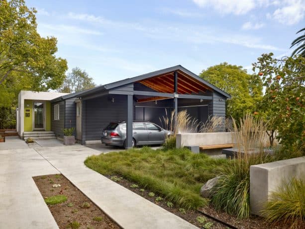 a modern, attached carport looks masculine because of its charcoal grey color