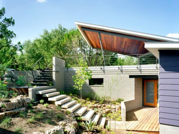 the carport is connected to the main entrance of the house with stairs