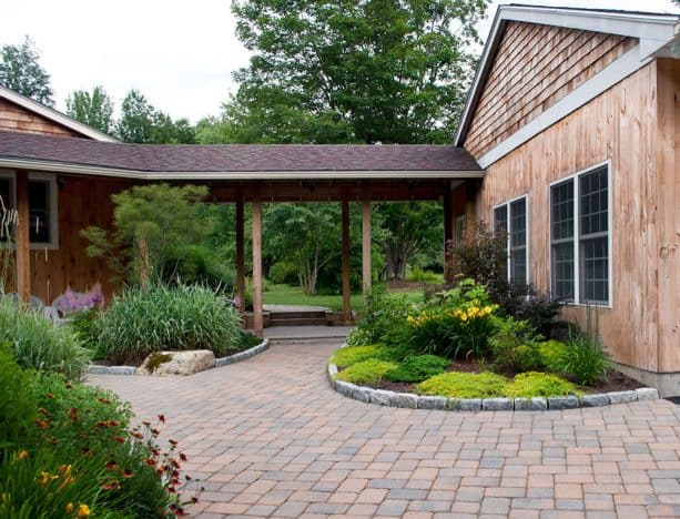 the covered walkway surroundings are nicely decorated with garden landscape