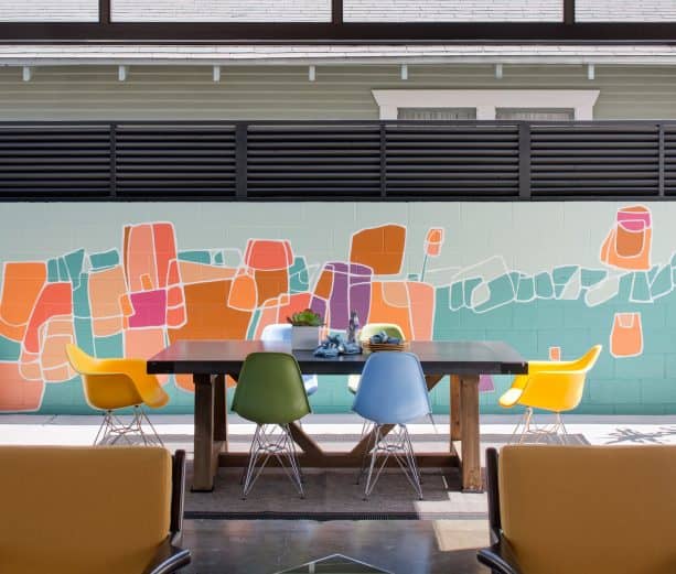 a cinder block wall with colorful mural for a more decorative patio